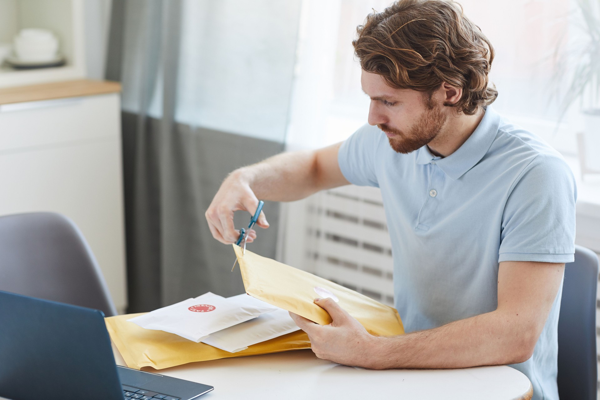 Man opening the envelopes
