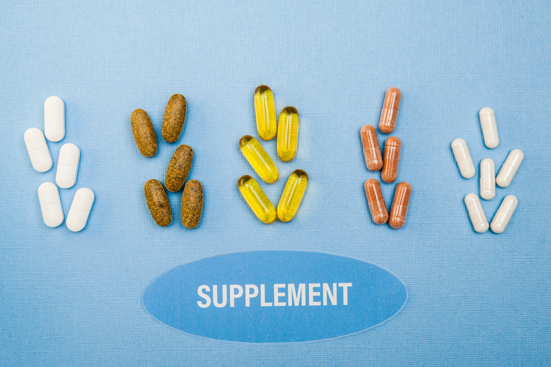 Supplements   on blue background , healthy product   concept close up,  flat lay